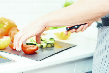 woman cutting vegetables in kitchen