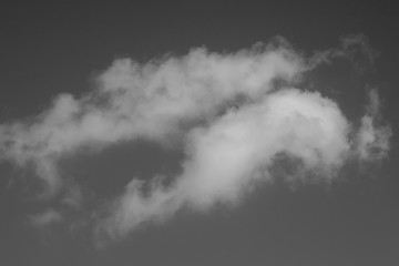 White clouds on a sky background. Black and white