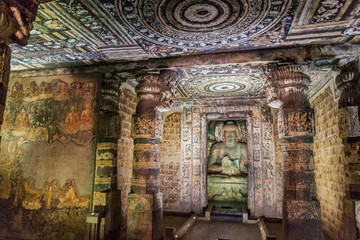 Fototapeta premium AJANTA, INDIA - FEBRUARY 6, 2017: Interior of a Buddhist cave carved into a cliff in Ajanta, Maharasthra state, India