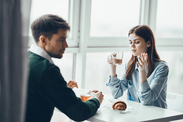 young couple having breakfast in the kitchen