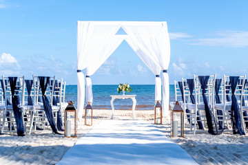 Blue themed wedding setup at the white sandy beach. Romantic getaway wedding. Horizontal
