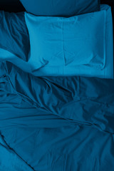 Bed linen of the blue classic color of the 2020 year.  Concept of the color of the year with copy...