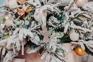 Christmas tree decorations. Different christmas ornaments, angels, balls, snowflakes on the tree. Christmas decorations design.
