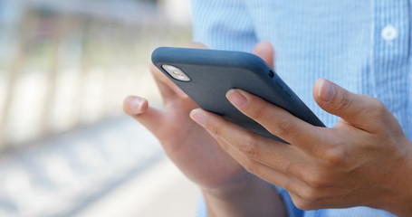 Woman touch on mobile phone in city