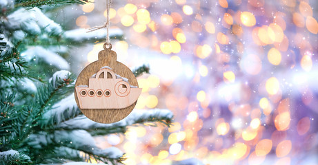wooden ship on Christmas tree. Christmas and New Year holiday concept. boat, symbol of travel, unusual handmade Christmas-tree decor in form of a ship. travel concept, copy space