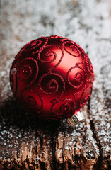 Christmas ball on snow flakes. Selective focus. Shallow depth of field.