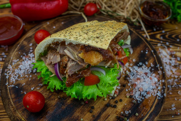 doner kebab on dark wooden kitchen table
