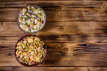 Set of festive mayonnaise salads on wooden table. Top view
