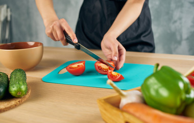 woman cutting vegetables in kitchen