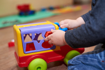 The child puts the figures in a sorter car, educational toys for children.