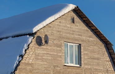 Brick house with snow on the roof