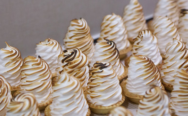 meringue cake in a basket shortbread dough background a lot of white brown crust meringue cake in a basket shortbread dough