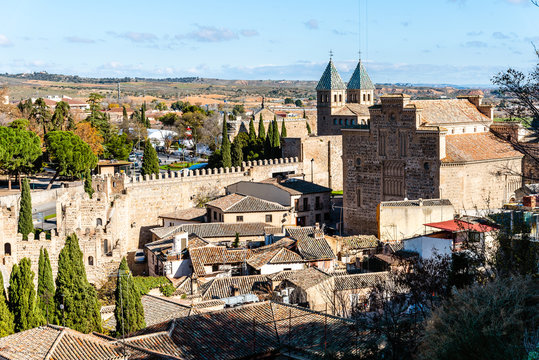 Cityscape of Toledo, Spain, from the ramparts with Puerta de la Bisagra and Santiago del Arrabal mudejar church