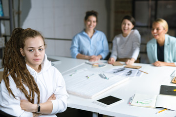 Young offended student or businesswoman suffering from her friends moaning