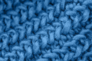 Blue knitted fabric closeup. Knitted wool background. Handmade.