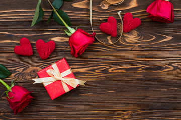 Background with gift box and hearts on wooden planks. Place for text. Top view with copy space.