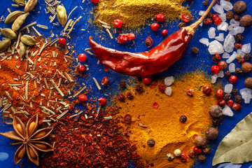 Wooden table of colorful spices. Top view