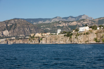  View of houses and hotels on the cliffs in Sorrento. Gulf of Naples, Campania, Italy