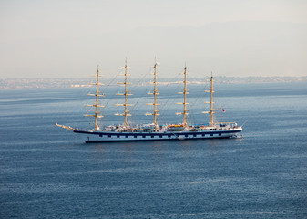 Fototapeta na wymiar A beautiful large sailing ship with lowered sails in the Gulf of Naples. Sorrento, Italy