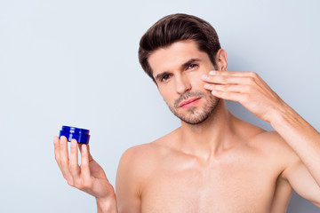 Close-up portrait of his he nice attractive bearded confident brown-haired guy applying smoothing gel treatment therapy anti age effect isolated on light white grey color pastel background