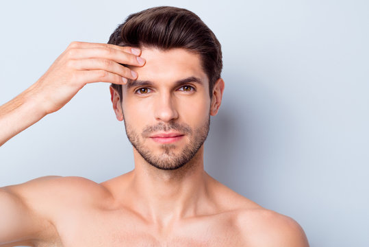 Closeup photo of macho guy perfect neat beard looking mirror touch forehead check skin condition salon procedure prevent wrinkles naked torso body isolated grey background