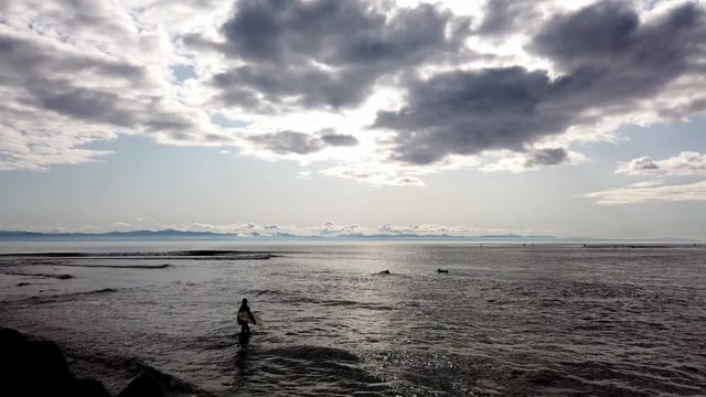 Time lapse of surfers going in and out of the Pacific Ocean at Jordan River camp ground on Vancouver Island