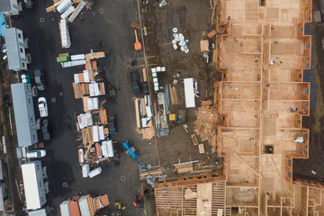Construction and construction of high-rise buildings, construction industry with working equipment and workers. View from above, from above.
