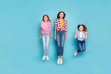 Full length body size photo of rejoicing nice white casual pin-up family spending their free time jumping wearing jeans denim while isolated with blue background