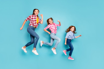 Fototapeta na wymiar Full length body size photo of rejoicing cheerful glad white pin-up family running after each other wearing jeans denim while isolated with blue background