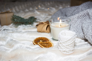 Fototapeta na wymiar Cozy winter composition. Candle, cinnamon, oranges and other cute elements