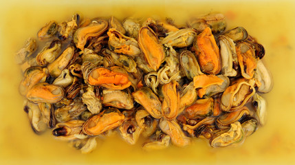 Delicious cooked vinegar preserved pickled mussels background