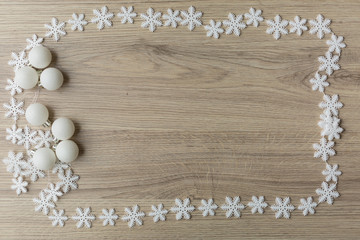 Backgrounds and textures.Snowflakes with Christmas toys on a wooden background
