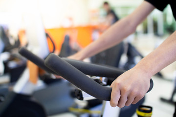 A man riding a bicycle in the fitness center