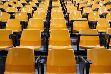 rows of yellow seats,empty room 