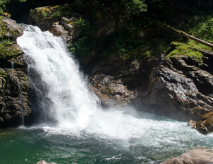 Thundering emerald colored punchbowl waterfall North Fork Sauk River Falls of the north cascades in a rocky gorge off Mountain Loop Highway in Darrington Snohomish county Washington State 