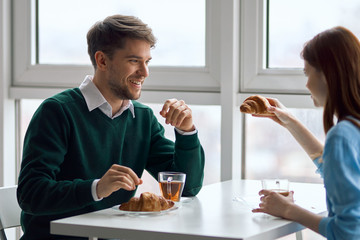young couple having breakfast in cafe