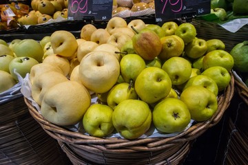 Variety of organic Asian pear or Chinese pear:Pyrus pyrifolia in baskets at the modern hypermarket.