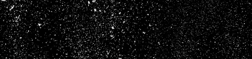Falling white snow isolated on a black background.