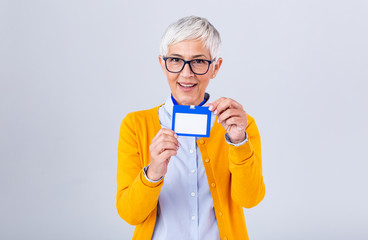 Woman wear blank vertical ID badge mockup, stand isolated. Name tag on neck and chest. Person identity label. Women in shirt uniform with empty id card mock up. Bussinesswoman lanyard design.