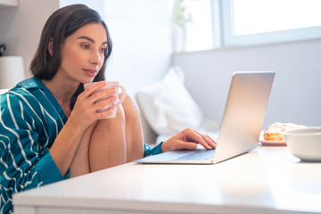 Chatting online and drinking tea stock photo