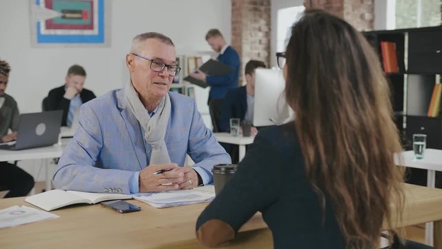 Senior businessman interviewing female candidate