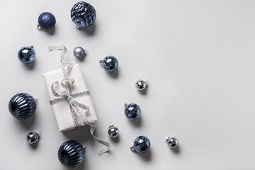 Christmas flat lay composition with clasic blue glass balls on grey. View fom above. Happy New Year. Space for text.