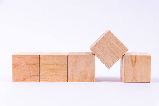 Row of five blank wooden blocks on a white background with copyspace for your text, letters or numbers.