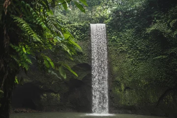 Fototapeten Wasserfälle Small secret waterfall Tibumana in Bali, Indonesia. Popular tourist landmark in green lush jungle. Nobody around, nature background.  © Oleg Breslavtsev