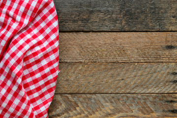 Obraz premium Table cloth on wooden table rustic background. Copy space for text, mock up. High resolution photography ready as a kitchen background.