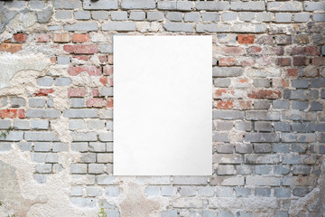 Poster mockup on an old brick street building wall. Clean, isolated paper for advertising presentation