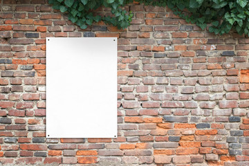 Blank poster attached to brick wall with copy space beside. Blank paper for print add presentation...