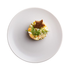 Traditional Russian Olivier salad decorated with toast star isolated on white. Top view.