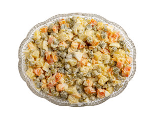 Traditional Russian Olivier salad in glass bowl on white background. Top view.