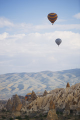 Hot air balloons flying over the rocky land